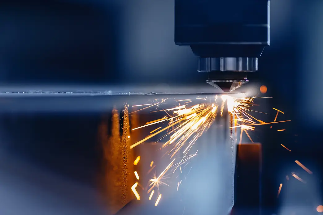 Laser cutting head processing sheet metal with flying sparks